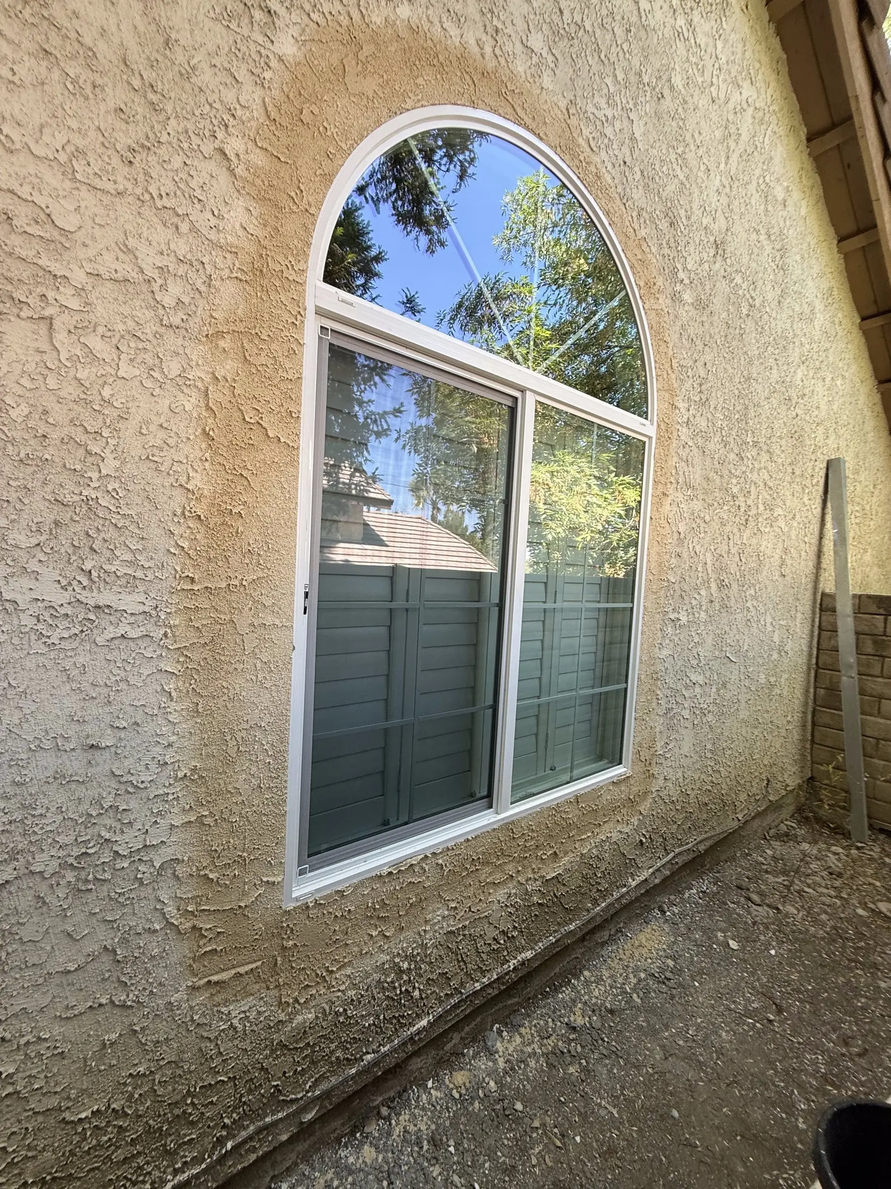 New arched retrofit window with white frame, finished install