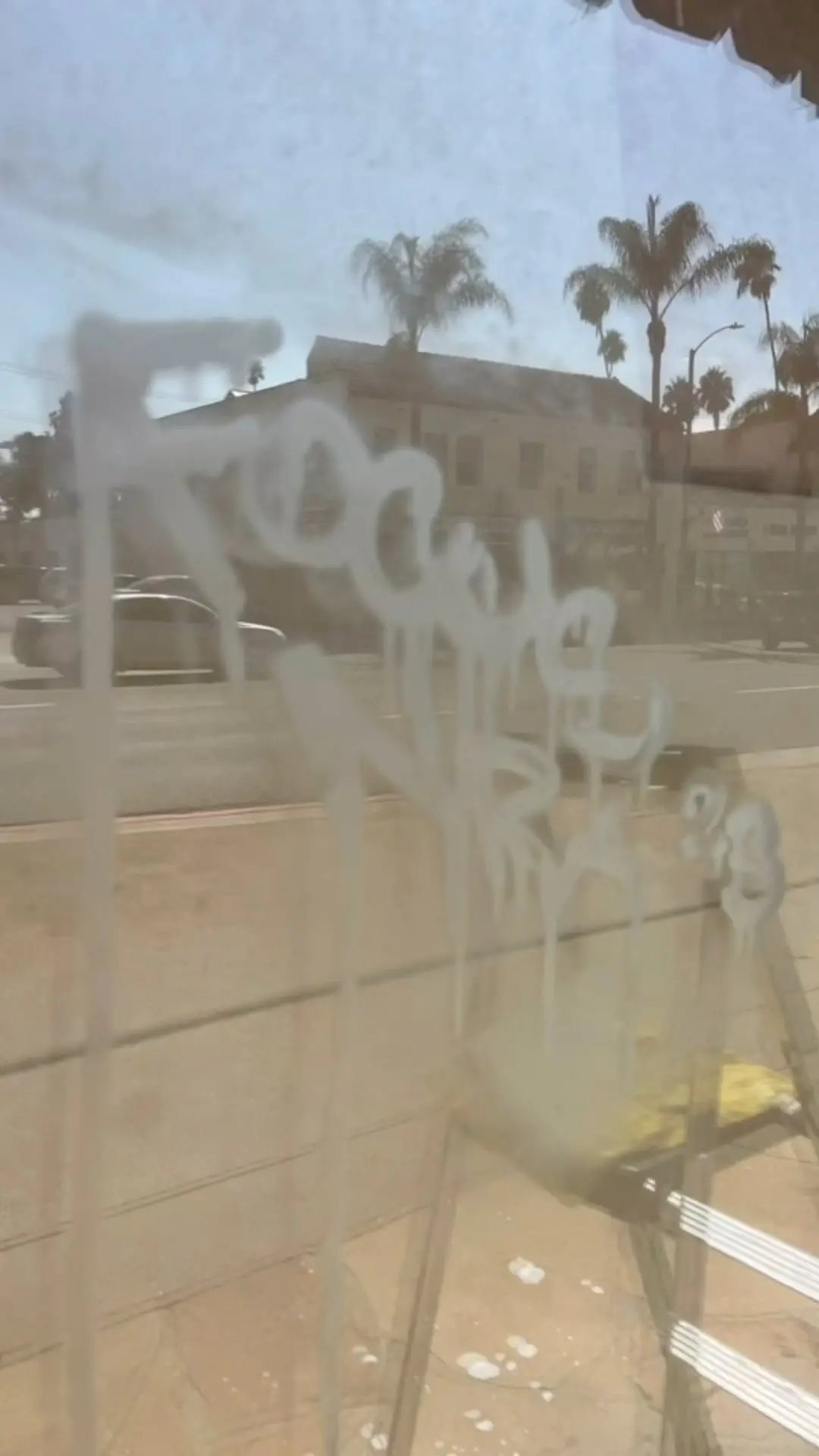 Scratched storefront glass before replacement