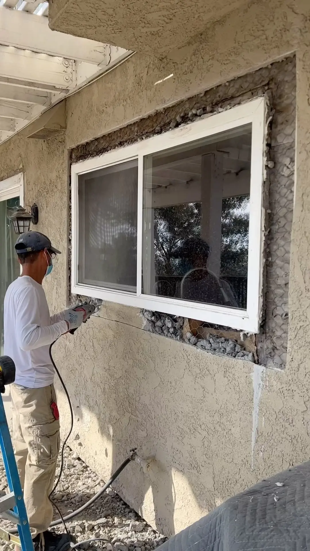 APL Glass technician setting a new window into a stucco opening
